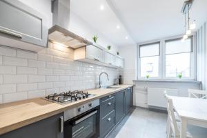 a kitchen with a sink and a stove top oven at VIP Apartments - Apartamenty na Szewskiej in Wrocław