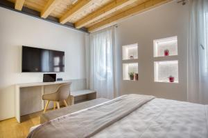 Llit o llits en una habitació de Ca' dei Battuti Apartments
