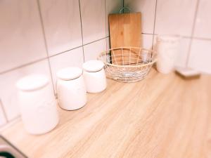 a group of white cups sitting on a counter at Apartament Wągrowiec, Gabi - Remigiusz Kiszka in Wągrowiec +37 photos