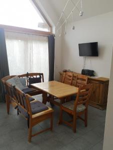 a dining room with a wooden table and chairs at 1Austragshaus Andermichlhof in Geltendorf