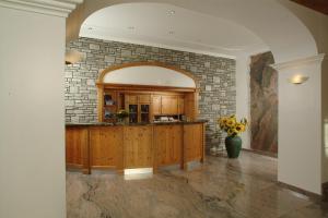 a kitchen with a stone wall and a counter at Airporthotel Salzburg - Hotel am Salzburg Airport in Salzburg