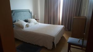 Łóżko lub łóżka w pokoju w obiekcie PISO EN MUROS (VIRGEN 3)
