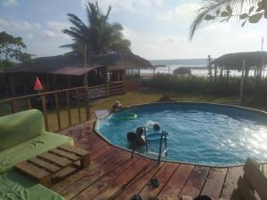 a swimming pool on a deck next to the beach at La Gondola in Montañita