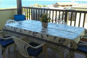 a table with a vase on it on a balcony at Stintino vista mare in Stintino
