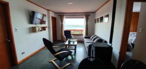 a living room with a couch and chairs and a window at Terrazas de Nercon in Castro