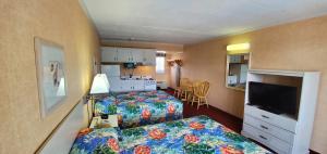 a hotel room with two beds and a television at Shangri-La Motel in Ocean City