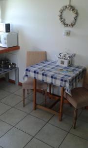 a table with a blue and white table cloth on it at Vlei Studio in Bettyʼs Bay