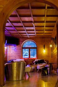 a room with chairs and tables in a room with a window at Hotel SNOW CHILL in Risoul +95 photos