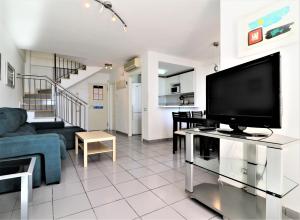 a living room with a large flat screen tv at Villa Marina in Benidorm