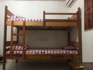 two bunk beds in the corner of a room at Hostel Manga Rosa in Santarém