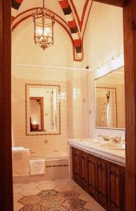 a bathroom with a large mirror and a bath tub at Castello Di Pavone in Pavone Canavese