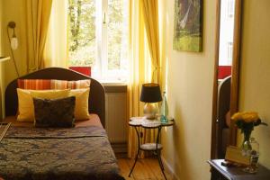 a small bedroom with a bed and a window at Boutique Hotel Mittendrin Berlin in Berlin