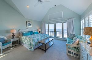 a bedroom with a bed and a view of the ocean at Point of View in Nags Head +114 photos