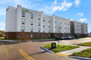 a large white building in a parking lot at Extended Stay America Suites - Colonial Heights - Fort Lee in Colonial Heights