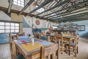a dining room with wooden tables and chairs at Hotel Aceitunos in Villa de Leyva