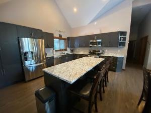 a large kitchen with a large island in the middle at Wolf Den in Valemount
