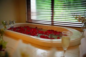 a bath tub filled with red roses in a bathroom at Dreams Playa Bonita All Inclusive in Playa Bonita Village