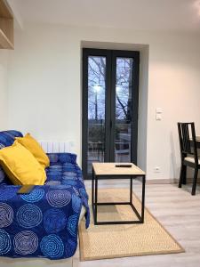 - un salon avec un lit et une table dans l'établissement Appart'Village Jouy La longère, à Jouy-en-Josas