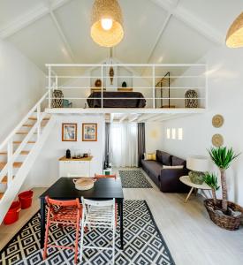 a living room with a staircase and a couch at Fisherman's Inn Loft in Montijo