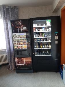 a black refrigerator with its doors open with food inside at Hotel Haarener Hof in Bad Wünnenberg