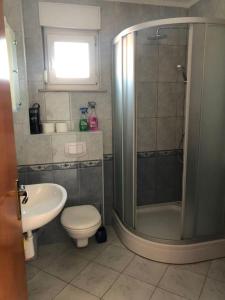 a bathroom with a shower and a toilet and a sink at Lili Murter in Murter +25 photos