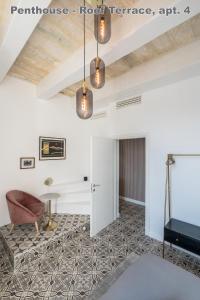 a living room with white walls and a ceiling at Valletta Hastings Suites in Valletta