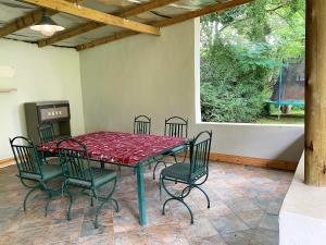 a table and chairs sitting on a patio at Skye High House & Cottage in Dullstroom