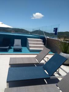 a group of chairs and a swimming pool at cabo frio praia do forte in Cabo Frio