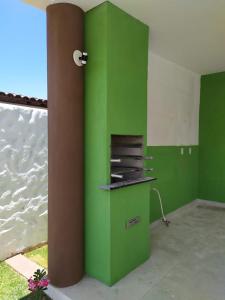 a green wall in a room with the water at GREEN HOUSE in Pipa