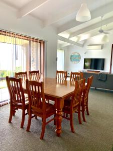 a dining room with a wooden table and chairs at Beachside House in Kingscote