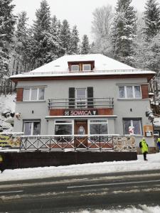 a building with a sign on it in the snow at Sowica in Karpacz