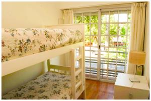 a bunk bed in a room with a window at El Piso de Arriba in Las Flores