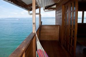 a balcony of a boat with a view of the water at M&M's Residencias in Bocas Town