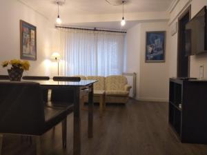 a living room with a couch and a table at Bnap Gesta in Oviedo