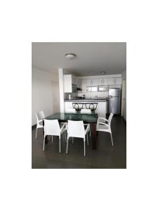 a kitchen and dining room with a table and chairs at Paracas Apartment in Paracas