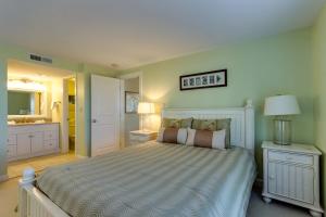 Un dormitorio con una cama grande y un baño. en Beach Club 341, en Seabrook Island 17 fotos más
