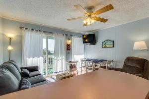 a living room with a couch and a table at Sea Cabin 228-B in Isle of Palms
