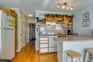 a kitchen with white appliances and wooden floors at Sea Cabin 228-B in Isle of Palms