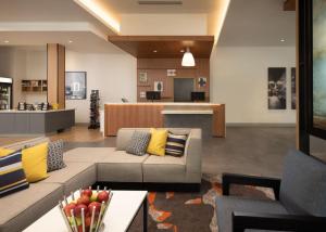 a living room with a couch and a table at Hyatt House San Jose Airport in San Jose