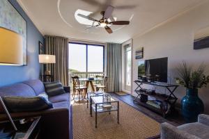 a living room with a couch and a tv at Shipwatch 2373 in Kiawah Island