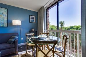 a room with a balcony with a table and chairs at Shipwatch 2373 in Kiawah Island