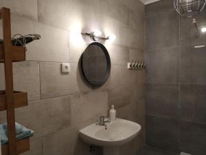 a bathroom with a sink and a mirror at Tavira Lovers - City Centre Apartment III in Tavira +10 photos