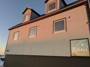 a building with windows on the side of it at Kulukis Downtown Hostel in Nuuk