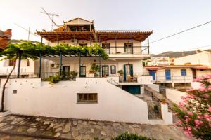 a house on a hill with flowers at Violetta Apartments in Neo Klima