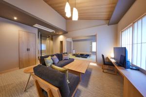 a living room with a couch and a table at Rinn Shirakawa South in Kyoto
