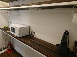 a microwave sitting on a counter in a kitchen at Miyajima Shiro in Miyajima