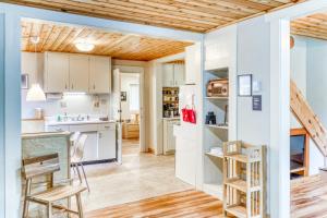 a kitchen with white cabinets and a wooden ceiling at Dunrovin Vintage Beach Cottage - 1 Bed 1 Bath Vacation home in Port Orford in Port Orford