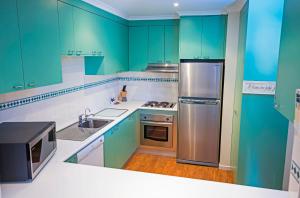 A kitchen or kitchenette at Merimbula Holiday Properties