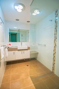 a bathroom with a sink and a shower at Merimbula Holiday Properties in Merimbula