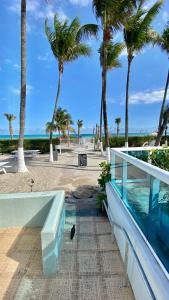 a view of the beach from a house with palm trees at Seacoast by Miami Ambassadors in Miami Beach